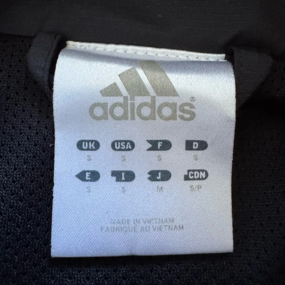 Vintage Adidas black, orange & white windbreaker jacket.  Men’s size small
